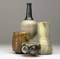 Vivika and otto heino  susan hughes  gerry williams four studio pottery pieces two stoneware vessels by vivika and otto heino a beakershaped vase with dipped glazes by susan hughes and a bottle