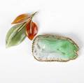 Jade and 14k gold brooches two pierced and carved pieces green to lavender depicts koi and aquatic foliage with brooch and appliances and rings for pendant wear together with a carnelian and jade le