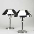 Nessen pair of chrome table lamps with nessen label together with a pair of cast stone table lamps