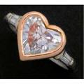Heartshaped diamond ring principal diamond 265 cts by formula bezel set in 18k rose gold flanked by tapered baguette cut diamonds 10 ct tw on a pt band size 6 12
