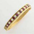 Aire ny hinged diamond and ruby bangle eleven fine brillant cut diamonds 161 cts tw alternate with thirteen graduated oval synthetic rubies 385 gs gw internal circumference 2 34