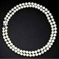 Mikimoto double strand akoya pearl necklace retailed by takashimaya ny ca 1960 in red leather case ninetynine pearls 8 mm  75 mm having a 14k wg clasp with diamonds and pearls length 17