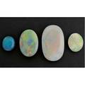 Four ummounted oval opals redyellow 41mm x 218mm 268 cts black redgreen harlequin 26mm x 16mm 1890 cts crystal opal full spectrum harlequin 154mm x 184mm 668 cts black opal blue
