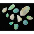 Eleven unmounted opals white and grey body colors with varying spectral pinfire pear cuts and oval cuts largest 58 cts 107 cts tw