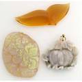 Three carved opals pumpkin shape with foliage greyblack body with redblue pinfire pendant mount foliate tablet translucent body bluegreen mexican fire opal sculpted in the form of lips 244