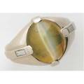 Gentlemans cats eye chrysoberyl and diamond ring 14k wg oval chrysoberyl strong chatoyency approx 10 cts 133mm x 113mm with baguette cut diamond accents 25 ct tw 119 gs gw size 7 14