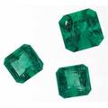 Three fine unmounted faceted emeralds matched emerald cut pair 316 cts tw 688mm x 56mm modified emerald cut 276 cts 84mm x 82mm all possibly columbian 592 cts tw
