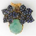 Buccellati green beryl and sapphire brooch oval cabochon beryl 19mm x 16mm represents fruit below two patinated leaves set with blue sapphire cabochons in 18k doublepin closure signed 174 gs g