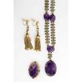 Amethyst and gold assembled suite 14k ca 1920 black enameled necklace with carved amethyst stations and drop oval carved amethyst brooch with seed pearl surround enamel accents bicolor fringe ea