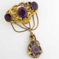 Victorian amethyst and gold festoon brooch rococo hollowform brooch with three faceted oval amethysts suspends a removeable pearshaped amethyst and 14k yg pendant approx 50 cts tw 322 gs gw 4