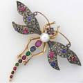 Diamond and gemstone dragonfly brooch silvertopped gold with diamond pave wings set with sapphires and rubies the body a 75 mm cultured pearl and a tapered line of rubies sapphires and emeralds