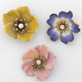 Three enameled gold flower brooches with diamonds ca 19101920 18k pink blossom centers pearl among diamond stamens french 14k yellow blossom centers pearl around diamond stamens american 14k p
