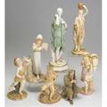 Royal worcester grouping of seven figurines late 19thearly 20th c sitting soldier no 2646 girl with tambourine no 1032 two basket carriers classical figure of a woman child blowing a horn