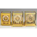 Lecoultre atmos clocks grouping of three in brass and glass cases largest 9