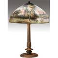 Handel table lamp with a chipped glass shade reversepainted with enamels depicting a moonlit landscape on a threesocket fluted bronzed base original patina base stamped handel shade stamped hand