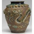 Chinese porcelain jar with dragon and lotus leaf relief design on flambe glaze 19th c 12 12