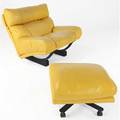 Tito agnoli  poltrona frau loungechair and ottoman upholstered in canary yellow leather the chair on adjustable arched base the ottoman on casters poltrona frau label chair 36 x 40 x 37 otto
