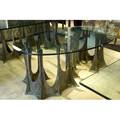 Paul evans sculpted bronze dining table with an elliptical plate glass top on a serpentine stalagmite base 1972 signed pe 72 26 34 x 72 x 37 34