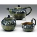 Newcomb college early threepiece tea set painted by mary sheerer with banded leaf and pod design in blue green and ivory on a green ground 1907 chip to inner rim of lid nick to spout of tea pot
