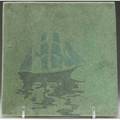 Marblehead tile with a tall ship on calm waters in green blue and brown from the collection of arthur baggs daughter mary trowbridge baggs tweet of tolland connecticut nick to bottom edge sh