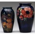 Moorcroft two vases one in the finches design the other anemone a few minor flecks and scratches overall both marked anemone with partial paper label 7 12 and 8 12