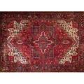 Persian heriz roomsize rug with a geometric medallion in ruby red olive and indigo on a ruby field with ivory spandrels and an unusual border ca 1970 9 x 11