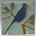 Van briggle tile decorated in cuenca with blue jay on branch against a pale blue ground a few flecks to high points framed unmarked 6 sq