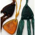 Rene lalique three pendants graines in dark green and dark amber glass and sorbier in yellow amber 1920 molded and engraved marks m pp 579 and 580 nos 1652 and 1658 2