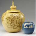 North dakota school of mines two vases one lidded carved by marie bentegeat thormodsgard with pine boughs and birds in glossy speckled yellow and pale brown the other by julia mattson with wolves i