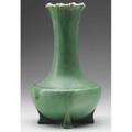 Teco bottleshaped vase with floriform rim on four feet covered in smooth matte green glaze lines and restoration to feet restoration to small area of rim stamped teco 13 12 x 7 12