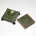 Grueby tile with a yellow tulip in heavy bronze footed base possibly tiffany studios matte green tile in copper frame pierced with butterflies first tile signed fv second stamped grueby tile bos