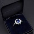 Fine tiffany  co blue sapphire and diamond ring platinum designed as a circular cluster cushion shaped sapphire 66mm x 68mm approx 150 cts surrounded by eight brilliant cut diamonds and di