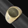 Cats eye chrysoberyl  diamond ring gypsy mounted oval chrysoberyl cabochon 128mm x 1125mm x 7mm approx 10 cts and two baguette cut diamonds 24 ct tw 1930 14k yg 138 gs size 7 12