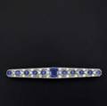 Art deco diamond and sapphire bar pin platinum with 18k wg pinback pierced and milgrained set with oec diamonds approx 1 ct tw center sapphire is synthetic of the period marked c  vr chapte