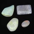 Four unmounted gem opals oval cut 10 cts rectangular fossil tablet from coober pedy 59 cts two irregularly shaped gems 122 cts 191 cts tw