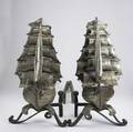 Pair of figural sailboat andirons 20th c in full sail with flags waving wrought iron with sheet metal sails 26