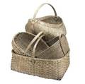 Four country baskets 19th20th c including large buttocks basket field basket coiled basket and woven splint basket largest 26 x 17 x 16
