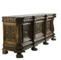 Oak sideboard ca 1880 heavily carved with foliage and three urn carved doors the center with a round medallion claw feet 42 34 x 115 x 27