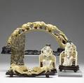 Five carved ivory pieces 20th c pair of seated women on chairs lions fighting over a ball intricately carved panel and carved tusk with figural elephants all on wood stands tallest 9 34