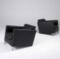Philippe starck pair of lounge chairs with black vinyl upholstery on finshaped aluminum front legs legs stamped starck 26 x 26 34 x 33 12