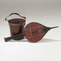 Jacques adnet firewood bucket along with black leather and red plaid bellows both with brass details 19 x 12 bellows 40 x 14