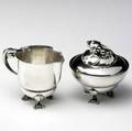 Georg jensen sterling silver cream pitcher and covered sugar bowl in the blossom pattern both stamped georg jensen denmark sterling cream pitcher 3 x 3 34 x 2 12 sugar bowl 3 34 x 3 38