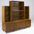 Morris sanders  mengel sevenpiece modular stacking cabinet with four open shelving units resting on three cabinets two singledoor and one doubledoor all with circular wood and brass pulls ca 1