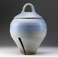 Karen karnes stoneware covered vessel with split base in speckled blue gray and terracotta glaze signed karen karnes in script 17 x 10 34 dia