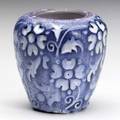 American encaustic tiling co unusual cabinet vase carved and enameldecorated with white blossoms on cobalt ground with a purple band around the rim we attribute the design of this piece to frederi