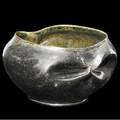 George ohr small squat vessel with two bowtie dimples the exterior covered in gunmetal green glaze the interior in mottled amber ge ohr biloxi miss 2 12 x 4