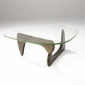 Isamu noguchi  herman miller coffee table with shaped pale yellowgreen glass top over twopiece wooden base an early first generation version of this table 15 34 x 50 x 36