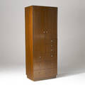 Directional walnut wardrobe with six drawers beneath two doors enclosing fitted drawers 71 12 x 27 x 19