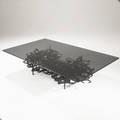 Style of ibram lassaw cocktail table with smoked plate glass top over sculptural steel base in dark patinated finish 16 x 60 x 36