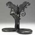 Style of edgar brandt art deco patinated metal stand with python base with grooved backing for mirror or artwork provenance collection of juan montoya 11 34 x 13 x 6